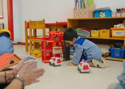 Niño jugando con autitos en área de construcción